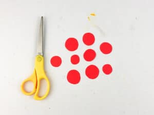cut small circles out of red paper for pizza