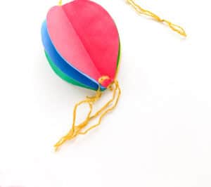 tie strings to holes at bottom of balloon